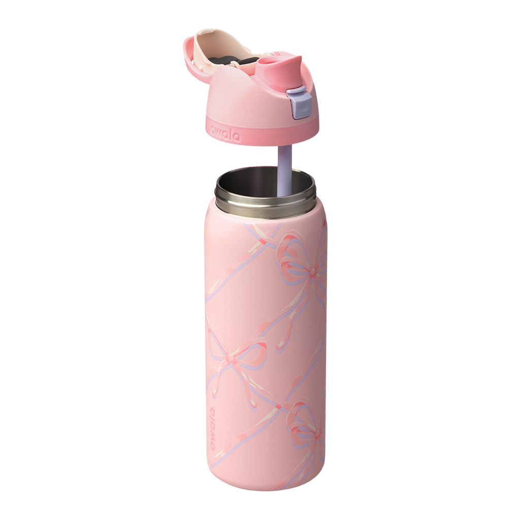 Owala FreeSip 32oz in Sugar Plum Fairy, light pink body with iridescent bow pattern, pink lid open showing cream FreeSip spout and pink carry loop with lilac push-button